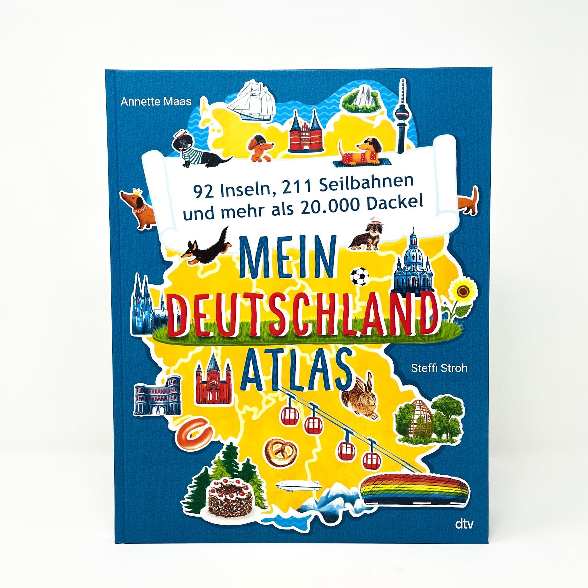 Buch: Mein Deutschlandatlas. Blauer Einband, Titel mit Illustrationen von Deutschland, Dackeln, Seilbahnen. Verlag: dtv.